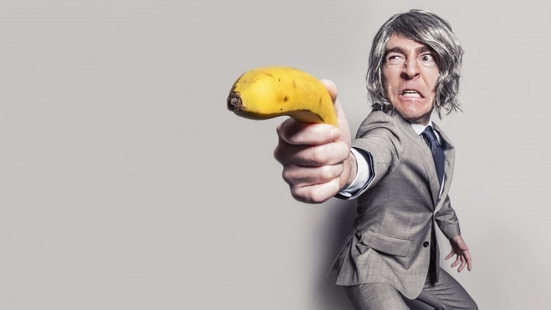 businessman-aiming-with-banana