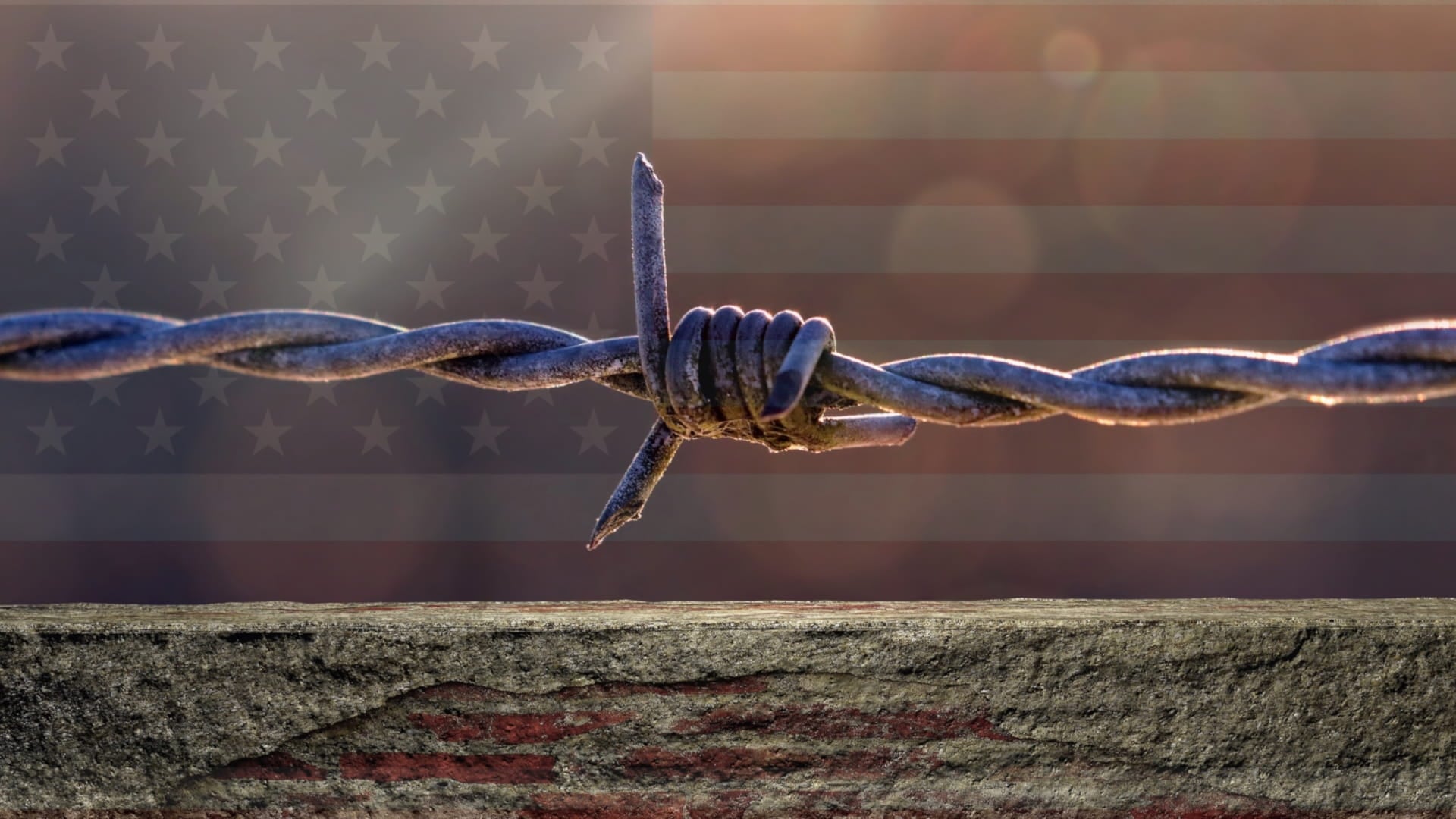 drut kolczasty na tle flagi USA