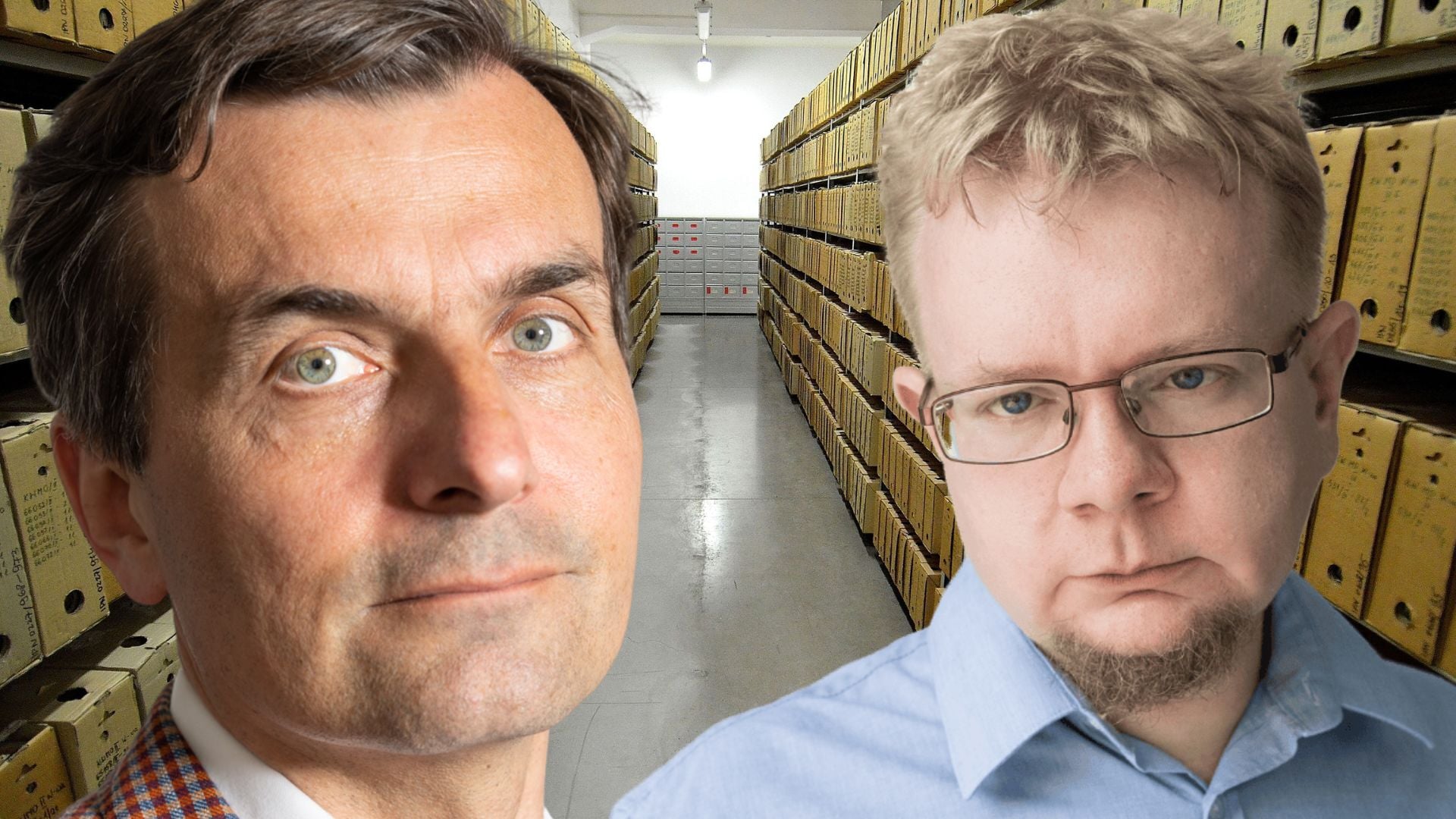 Two men pose in a storage warehouse; tall shelves with yellow boxes line the aisle behind them.