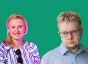 Smiling woman in a striped blouse with sunglasses hanging from her neckline beside a serious man in a blue shirt and glasses against a green backdrop.