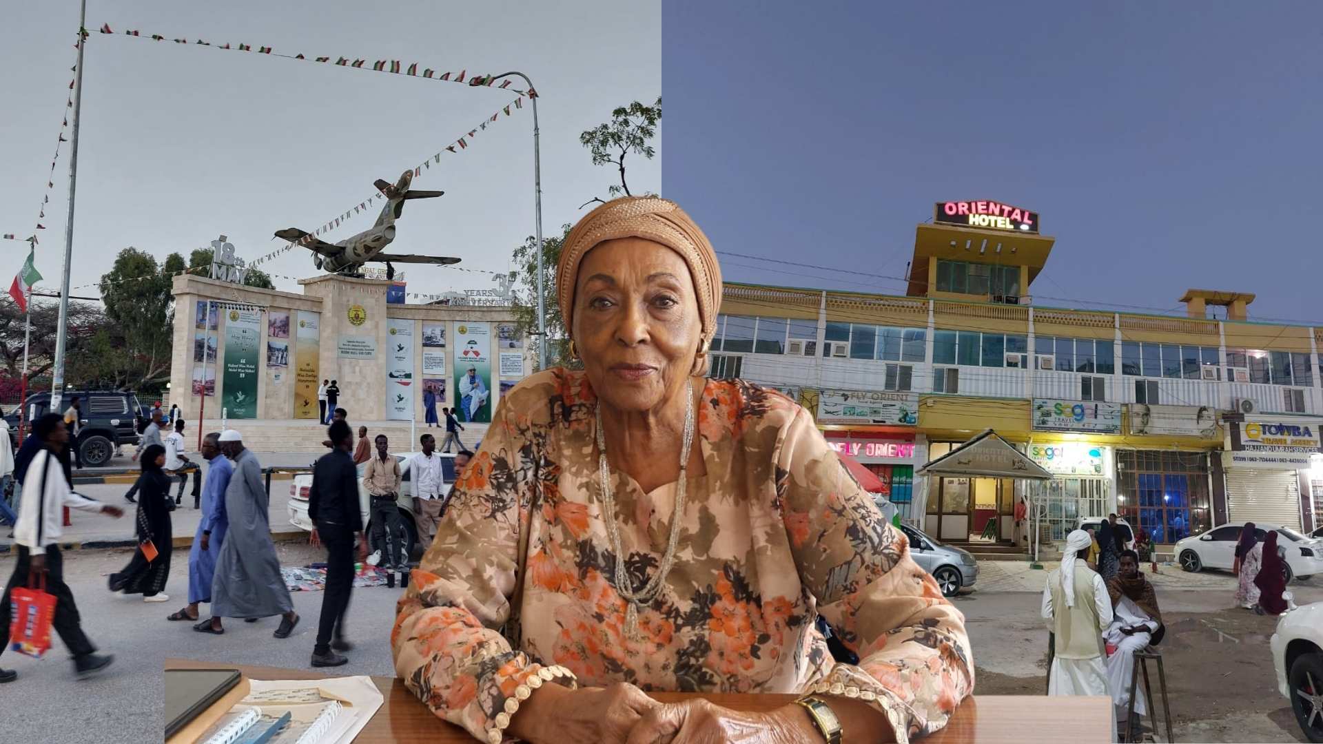 Elderly woman in a floral outfit and headwrap sits at a desk in a busy town square, with an airplane statue and hotel in the background.