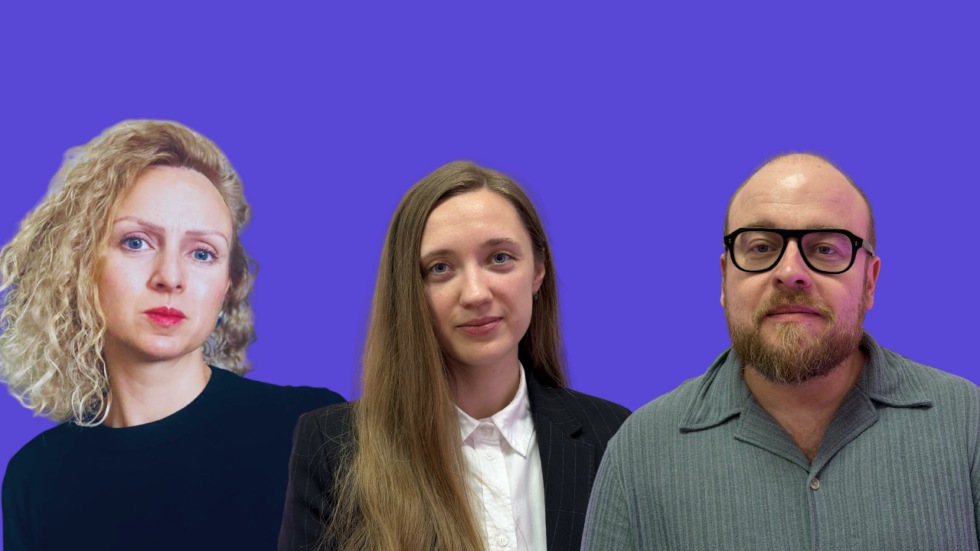 Three professionals posing for a group photo against a purple backdrop: a curly-haired woman on the left, a woman in a blazer center, and a man with glasses on the right, all looking at the camera.