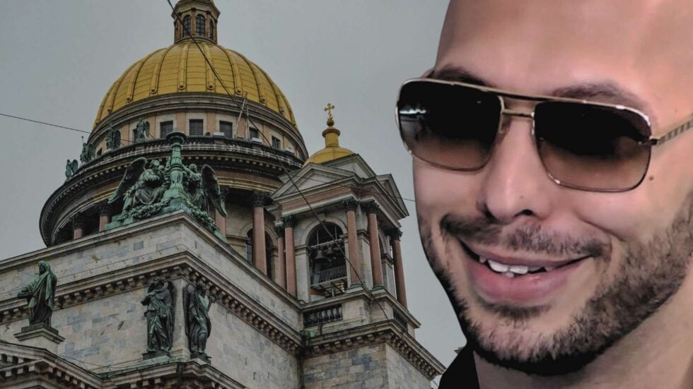 Partial image showing a man wearing dark sunglasses smiling on the right, beside a historic building with a large gold dome and sculpted statues on the left.