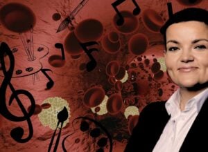Smiling woman in professional attire against a red, science-themed background with blood cells and musical notes.