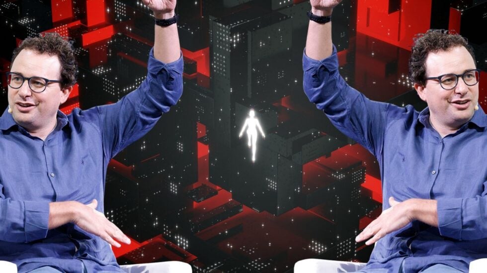 Two identical men in blue shirts and glasses raise their arms in the air against a red, black, geometric digital background with a glowing white humanoid figure in the center.