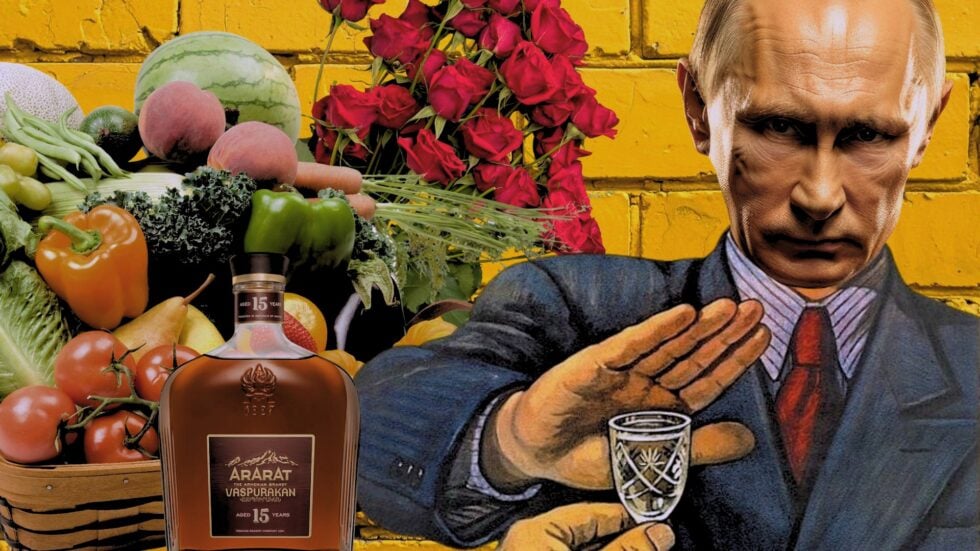 Bold collage featuring a bottle of Ararat Armenian brandy beside a basket of vegetables and bright red roses against a yellow brick wall.