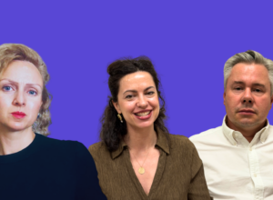 Three adults posing for a team photo against a solid purple background: left a woman with curly blonde hair, center a smiling brunette in a brown blouse, right a man with gray hair in a white shirt.