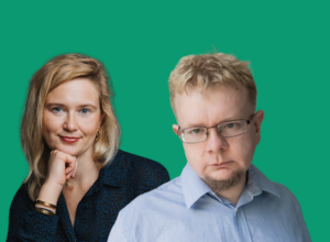 Two colleagues posing together against a green backdrop: woman smiling softly on the left, man with glasses on the right looking at the camera with a neutral expression.