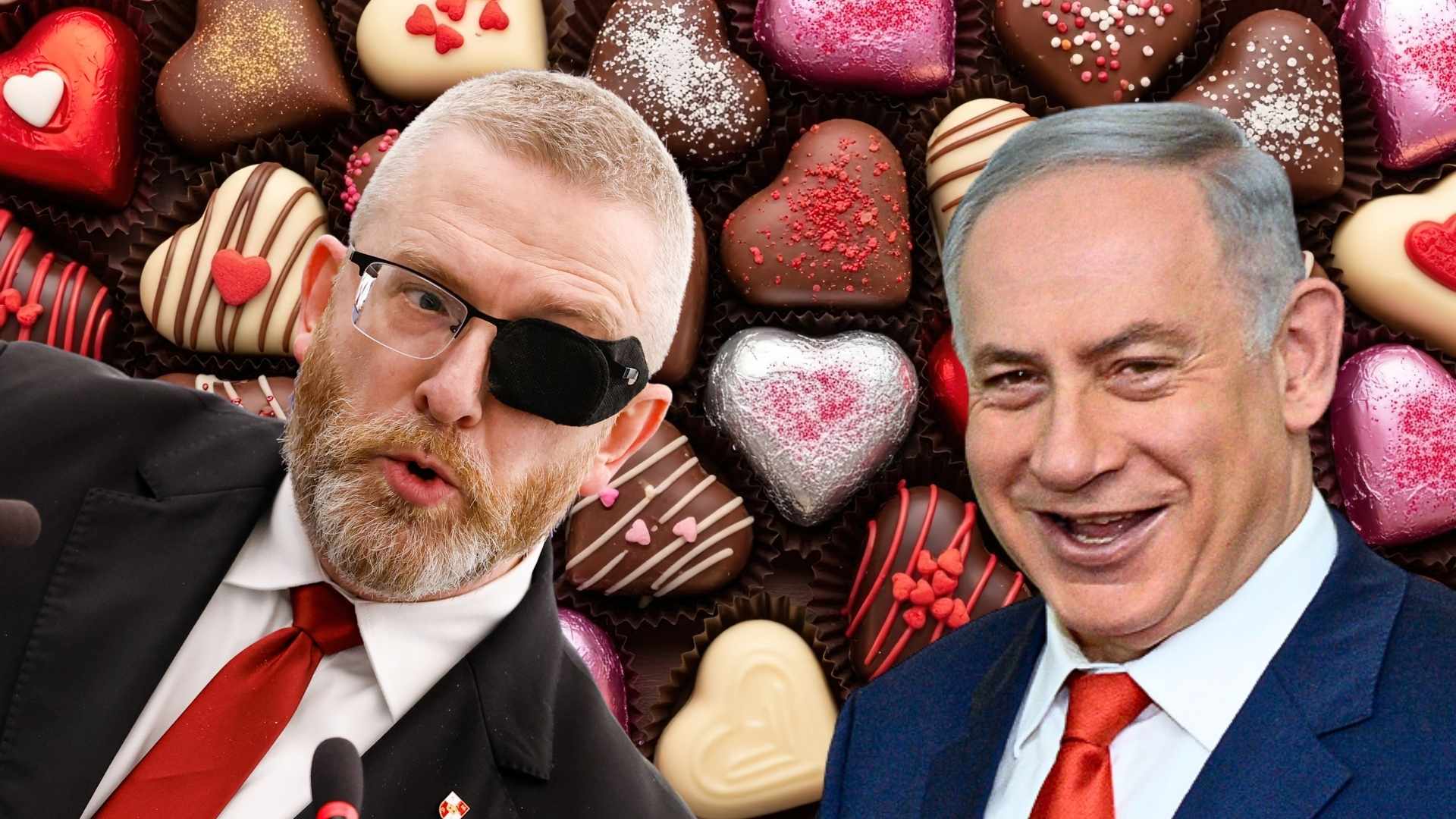Two men in suits with red ties leaning toward the camera, one wearing an eye patch, smiles with a background of heart-shaped chocolates.