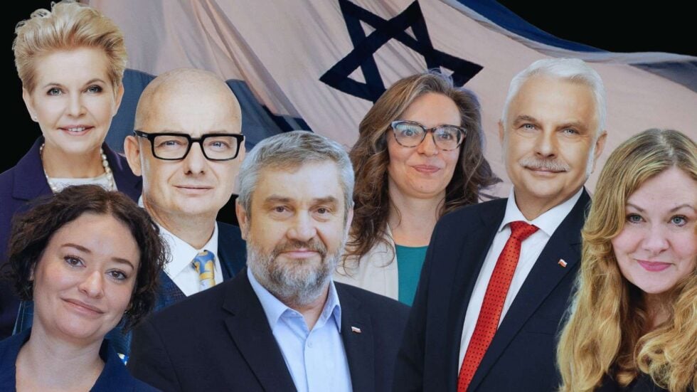 Seven professionally dressed adults posing for a group photo with a large flag featuring a blue Star of David motif in the background.