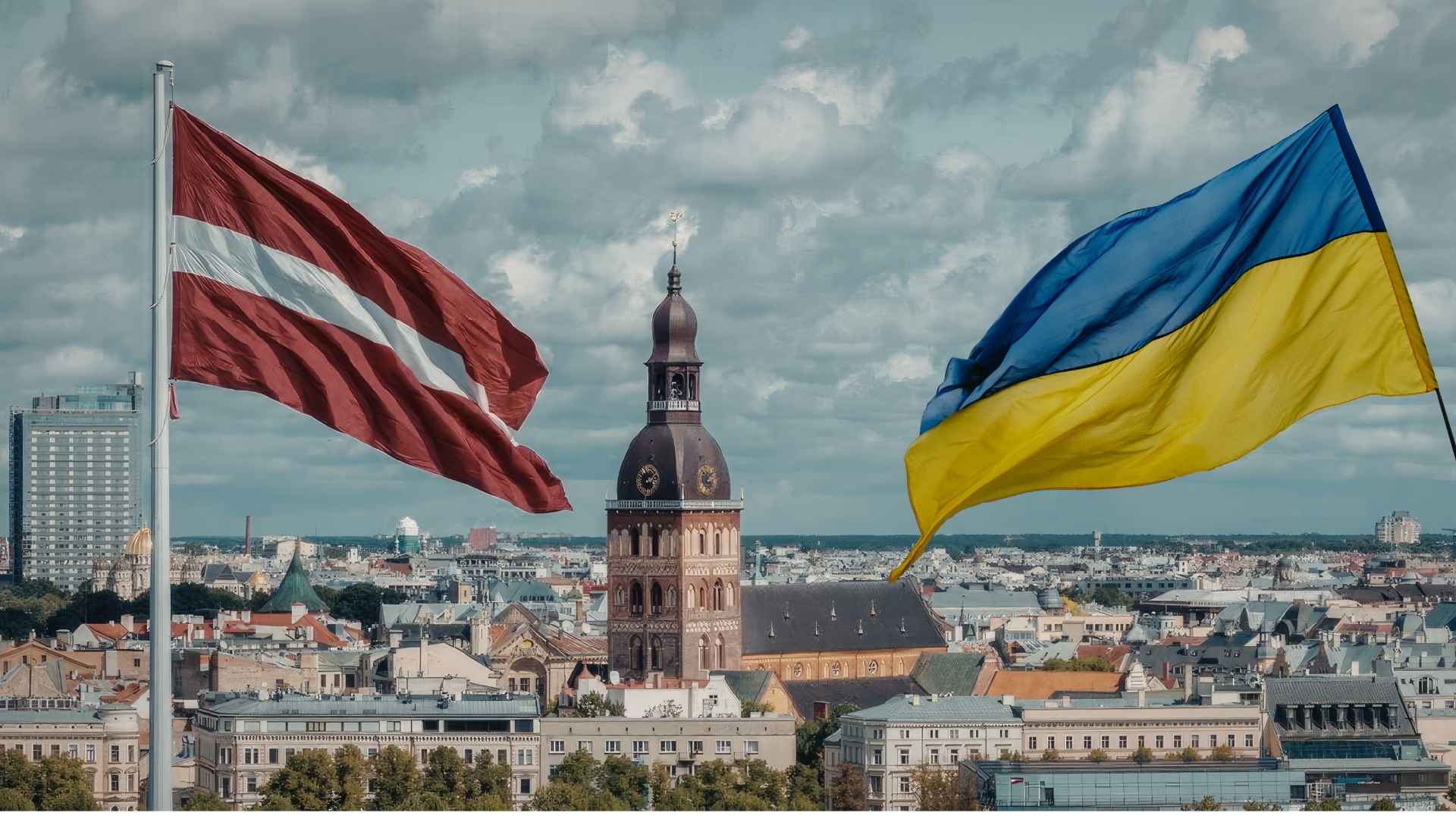Two national flags (Latvia and Ukraine) flutter above a European city skyline, with a domed church tower in the center.