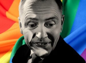 Czarno-biały Karol Nawrocki na tle tęczowej flagi