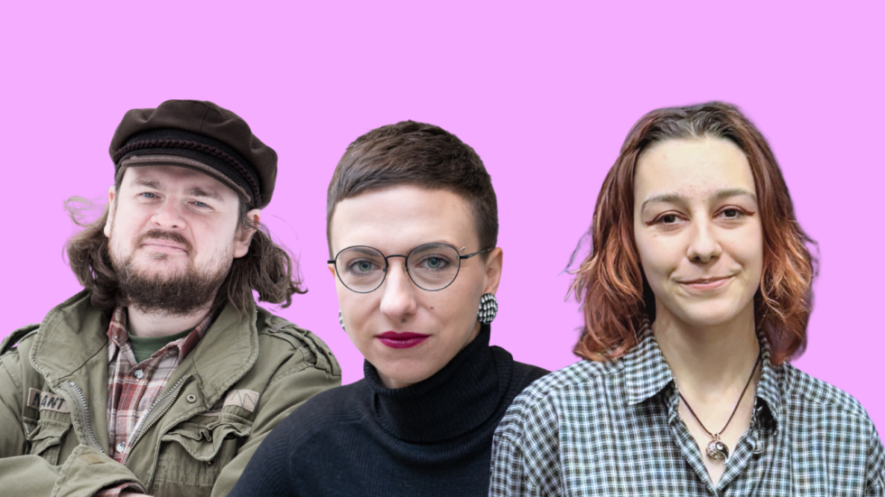 Three adults posing for a photo against a pink background: a bearded man in a cap and olive jacket on the left, a woman with short hair and round glasses in the center, and a woman in a checkered shirt on the right.