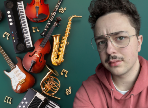 Portrait of a young man with glasses and a pink hoodie beside a scattered collection of musical instruments (guitar, violin, saxophone, keyboard, accordion) on a green background.