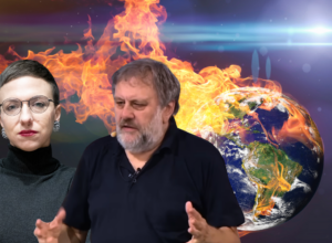 Two presenters sit against a dramatic backdrop of a burning Earth, signaling a discussion about climate disaster or environmental crisis.